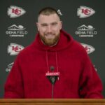 Travis Kelce smiles during a press event announcing his investment in Six Flags amusement parks.