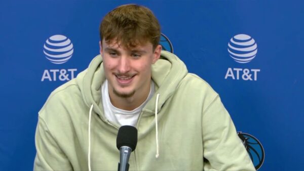 Cooper Flagg signing autographs for young fans near the court.