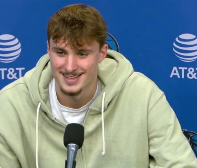 Cooper Flagg signing autographs for young fans near the court.