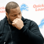 Ndamukong Suh not watching TV, seated and focused in a quiet room.