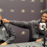 Shedeur and Shilo Sanders posing at the Amiri fashion show in Paris, embodying NFL energy in a luxury setting.