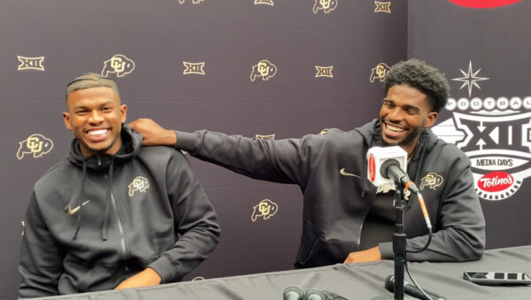 Shedeur and Shilo Sanders posing at the Amiri fashion show in Paris, embodying NFL energy in a luxury setting.
