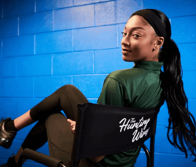 Angel Reese Chicago Sky star, announces adding Netflix to her offseason plans while smiling for the camera.