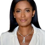 Swin Cash at a podium with the Women’s Sports Foundation logo, announced as the new president while new board members look on.