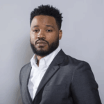 Director Ryan Coogler, shown in a thoughtful pose, reflecting on his unlikely path from football and finance to filmmaking.