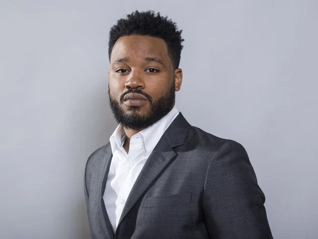 Director Ryan Coogler, shown in a thoughtful pose, reflecting on his unlikely path from football and finance to filmmaking.